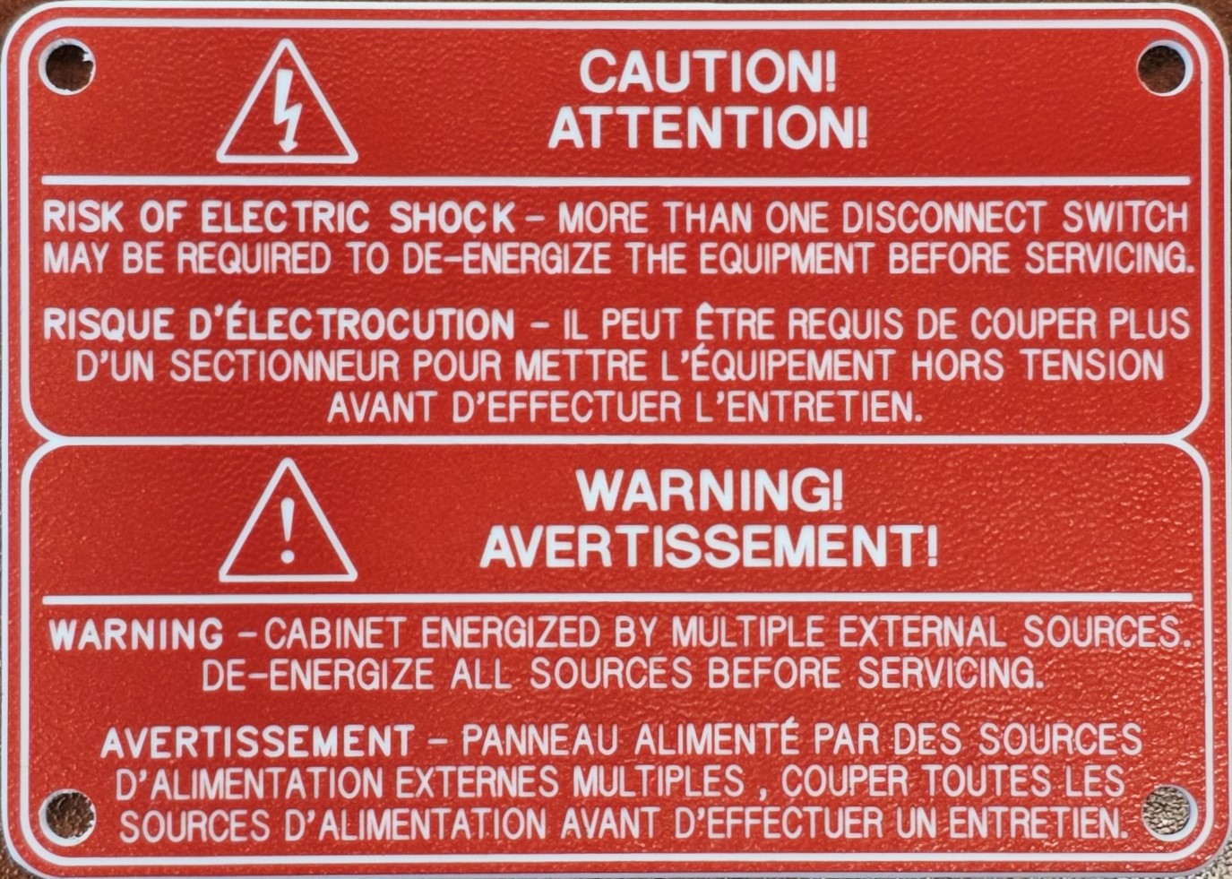 warning plate engraved on red plastic